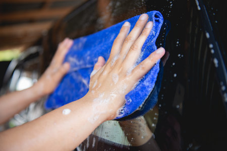 Manual car wash with blue car wash cloth