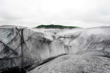 Vatnajokull Big Glacier with ice mountains and green mountains in the backgroundの写真素材
