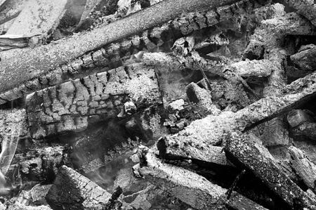 Black and white photo of burning woodの写真素材