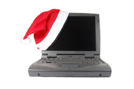Santa's red hat on a laptop isolated on whiteの写真素材
