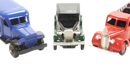 Three toy cars over a white backgroundの写真素材