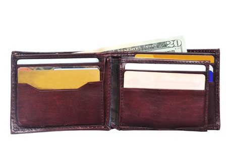 An open leather wallet with a twenty dollars  bill isolated on whiteの写真素材