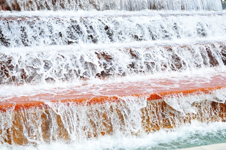 Macro shot of water flowing down in a water fountainの写真素材
