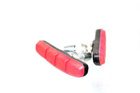 Macro shot of bicycle brake pads replacements isolated on whiteの写真素材
