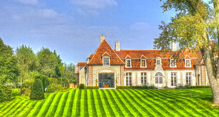 HDR photograph of a Beautiful old country home with a nice lawn and gardenのeditorial素材