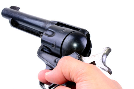 hand holding a six shooter revolver isolated on white