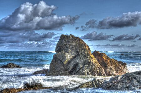Sun shining on ocean rocks at a beach in Pedasi Panamaの写真素材