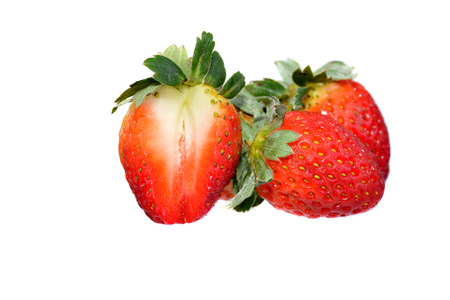 Fresh strawberries with one being sliced on a white backgroundの写真素材