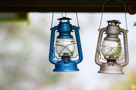 Close up of two lantenrs hanging outside a mountain cabinの写真素材