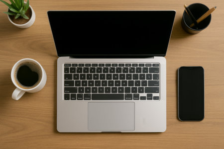 AI-generated image of a modern office desk flat-lay with laptop, smartphone, and coffee, showcasing a clean and professional workspace.の素材