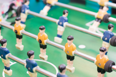 Players of the game of Foosball in orange and blue colorの写真素材