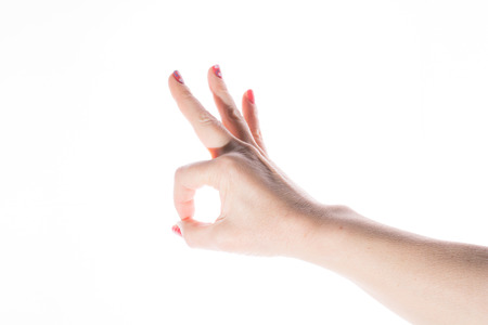 Hand shows a sign on a white backgroundの写真素材