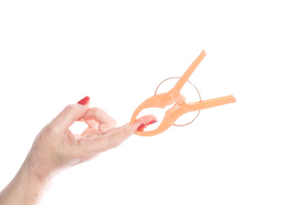 hand with plastic clamp isolated on white backgroundの写真素材