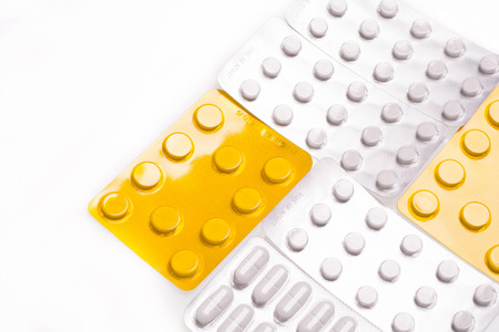 Blisters with pills on a white background for the treatment of illnessesの写真素材