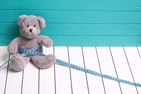 Teddy Bear toy alone on wood in front mint green backgroundの写真素材