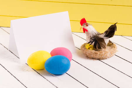 Colorful Easter eggs and empty white sheet of wood backgroundの写真素材