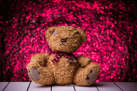 Teddy Bear toy alone on  wooden floor with nice bokeh backgroundの写真素材