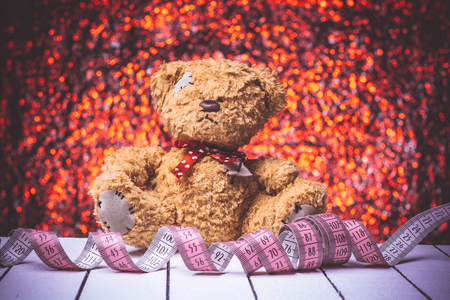 Teddy Bear toy alone on  wooden floor with nice bokeh backgroundの写真素材