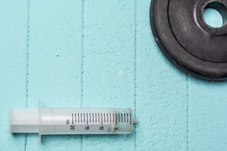 Injection and disc from dumbbell. Close up.の写真素材