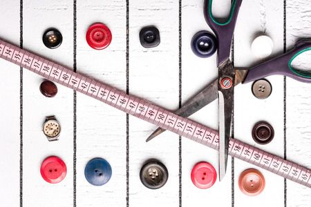 Buttons, centimeter and scissors. Cutting and creating fashionable clothesの写真素材