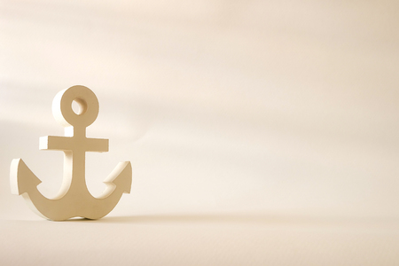 Wooden anchor with decorative vintage style in empty backgroundの写真素材