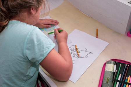 blonde girl drawing with colored pencils a beautiful greeting card for her mother with the text I...