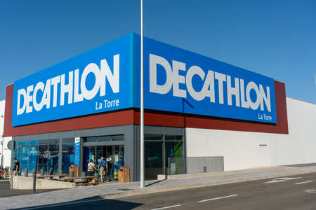night view of the Puerto Venecia leisure and restaurant shopping center with the illuminated shop signs and the jetty with the moored boats. July 28, 2021. ZARAGOZA, SPAIN.のeditorial素材
