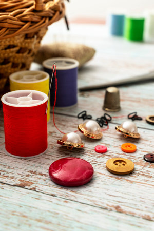 vertical take of elements for sewing such as spools of thread of different colors in focus and a...