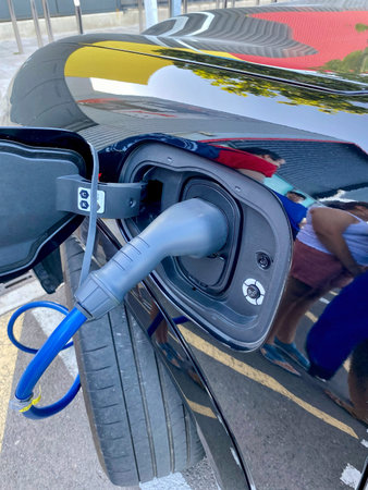 Charging the battery of a modern electric car on the street