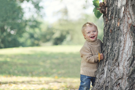 Positive child having fun in warm autumn day, copy spaceの写真素材