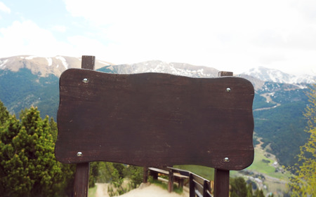 Wooden board signboard or sign on a mountain backgroundの写真素材