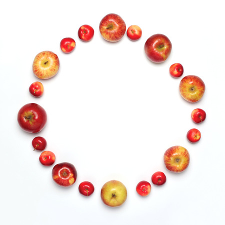 Food concept - many apples fruits in the shape of circle isolated on a white background, flat lay, empty copy spaceの写真素材