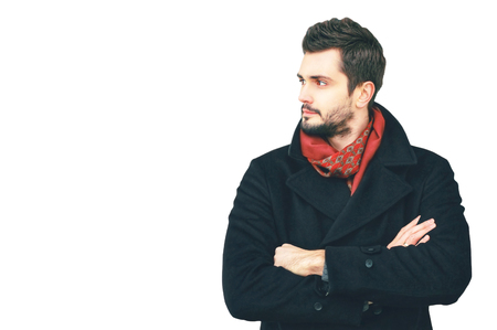 handsome man crossed his arms looks aside isolated on a white backgroundの写真素材