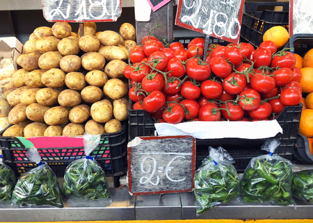 Potatoes, tomatoes, vegetables in the boxes market close-upの写真素材