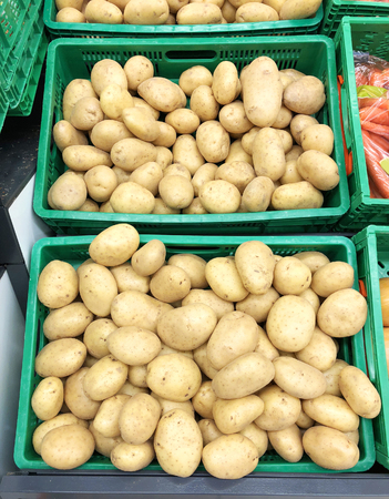 Yellow potatoes in the boxesの写真素材