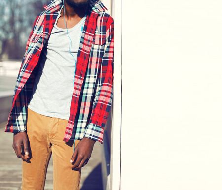 Fashion african man listens to music in the cityの写真素材