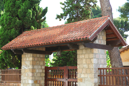 Stone gate and the tiles on the roof, decorated facadeの写真素材