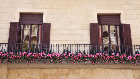 view of european balcony with windows and flowersの写真素材
