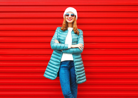 Fashion pretty smiling woman on a red background in the cityの写真素材