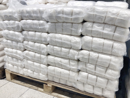 many sacks of sugar in warehouse on palletsの写真素材