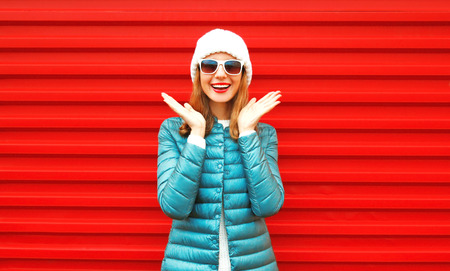 Portrait happy smiling woman laughs on a red backgroundの写真素材