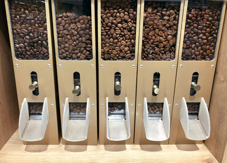 Coffee beans in containers dispensers for self-service in supermarketの写真素材