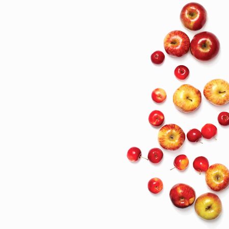 Many different scattered red apples isolated on white backgroundの写真素材