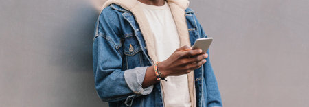 Close up of african man with smartphone on city street