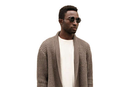 Portrait of stylish young african man model wearing a knitted cardigan isolated on a white backgroundの写真素材