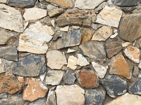 Old ancient wall with different stones as abstract backgroundの写真素材