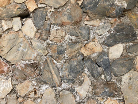 Old ancient wall with different stones as abstract backgroundの写真素材