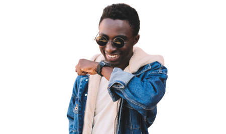 Portrait close up happy smiling african man with smart watch using voice command recorder or takes calling isolated on a white backgroundの写真素材