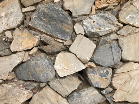 Old ancient wall with different stones as abstract backgroundの写真素材