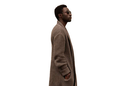 Fashionable portrait of stylish african man model looking away wearing knitted cardigan isolated on white backgroundの写真素材